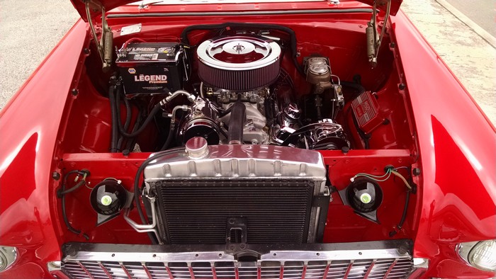1955 Chevy with hood up shows engine and radiator