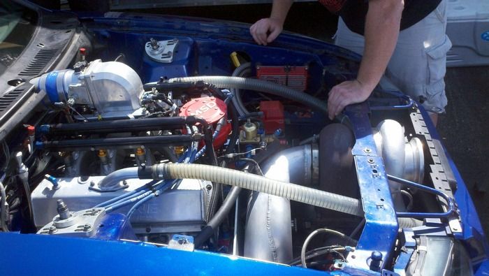 1969 Ford Mustang Mach 1 Twin Turbo Hemi inspecting engine